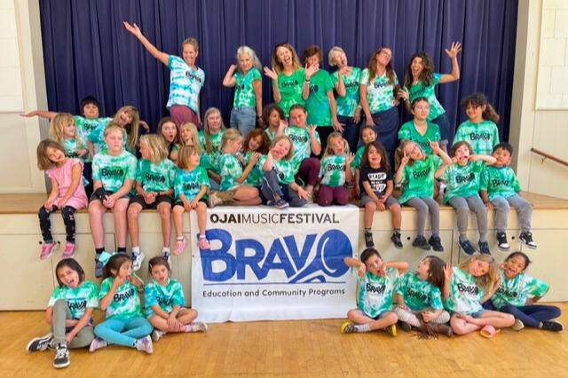 Campers and instructors smiling for group photo all in tie-dye Bravo t-shirts